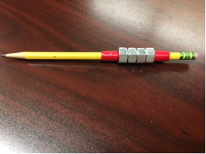 This is a picture of the pencil with 4 hex nuts and tape at the top and bottom of them