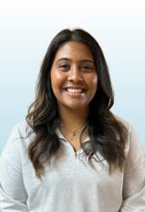 woman with brown hair smiling into the camera